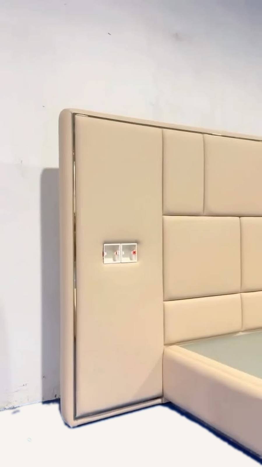 The headboard is upholstered in light tan
