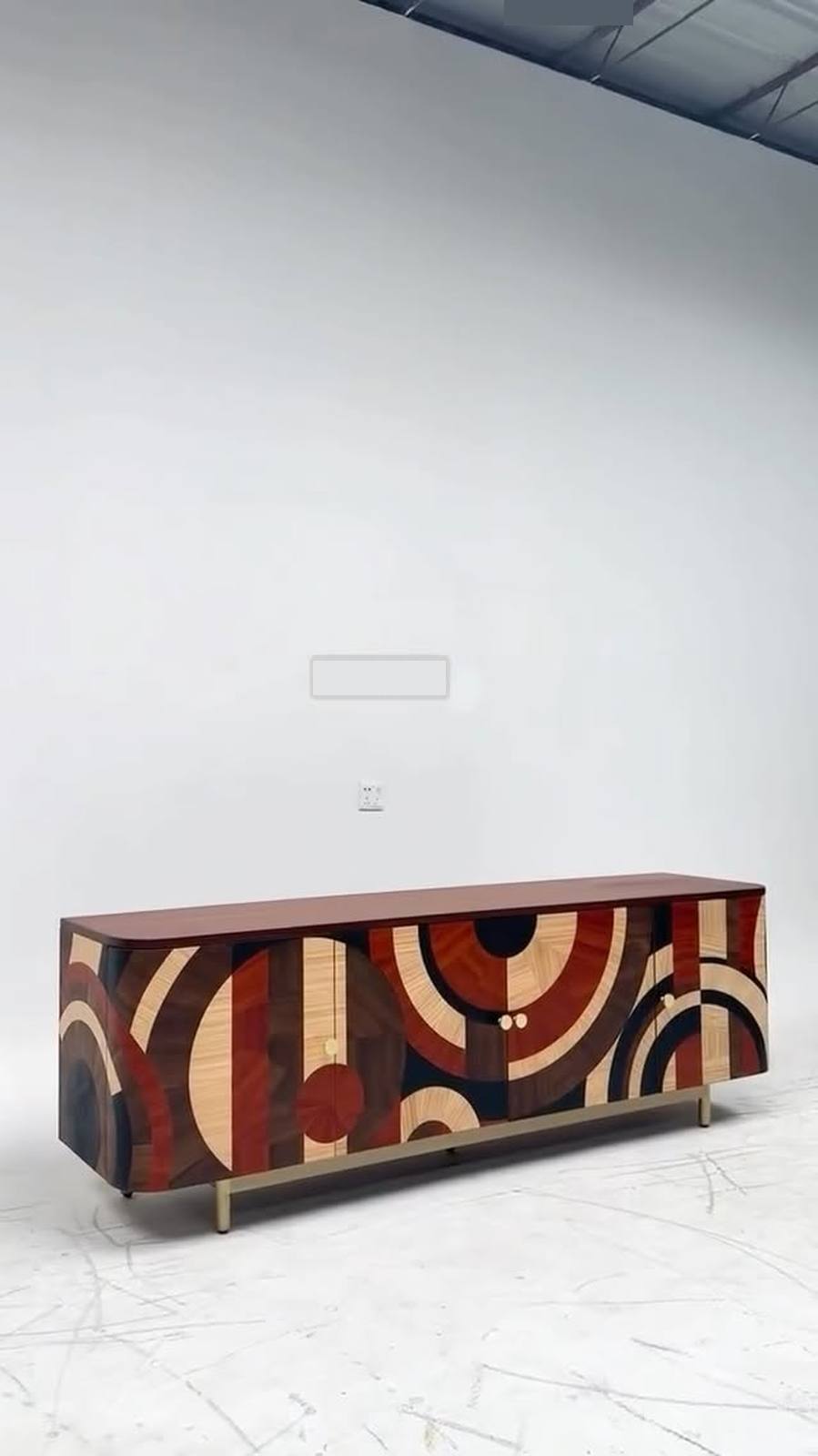 Geometric wood art & slim brass legs.